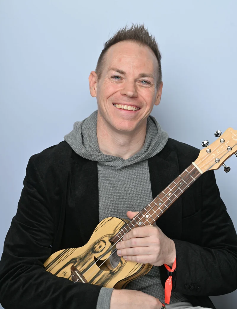 Ryan smiling with his ukulele